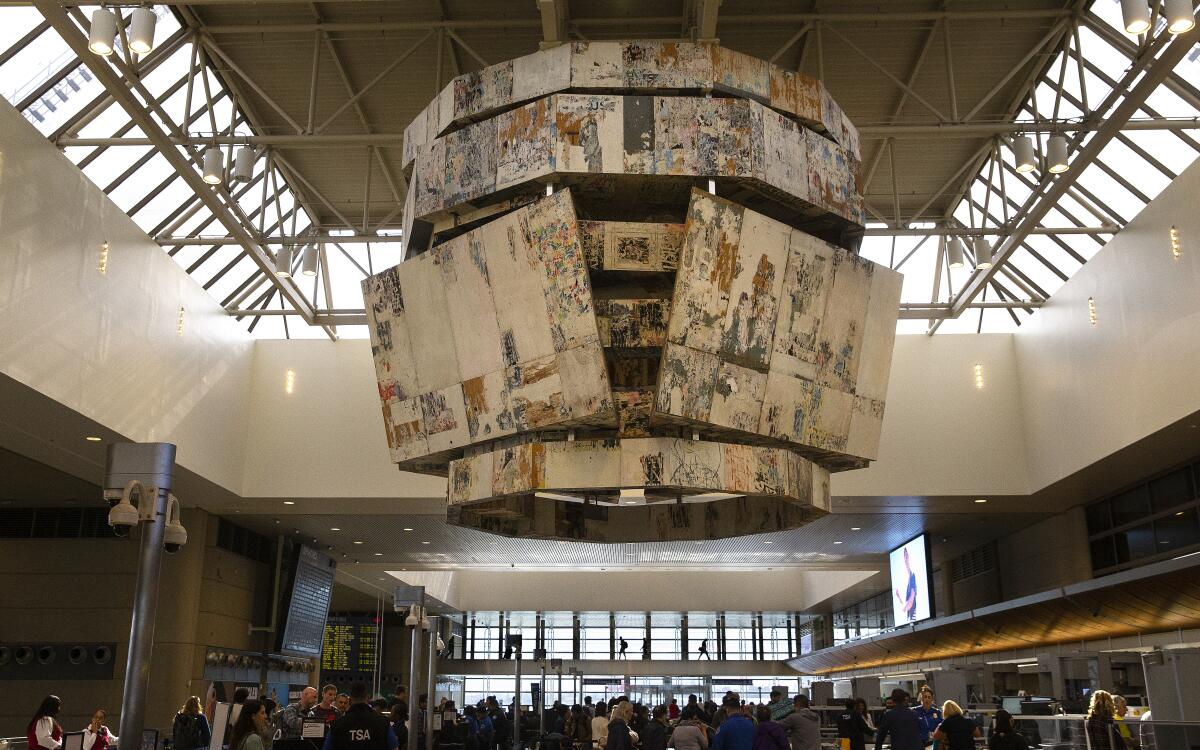 Bell Tower, a 30-by-26-foot art installation, consisting of an aluminum structure with wood/paper panels, by artist Mark Bradford, is on exhibit in the Tom Bradley International Terminal at Los Angeles International Airport.