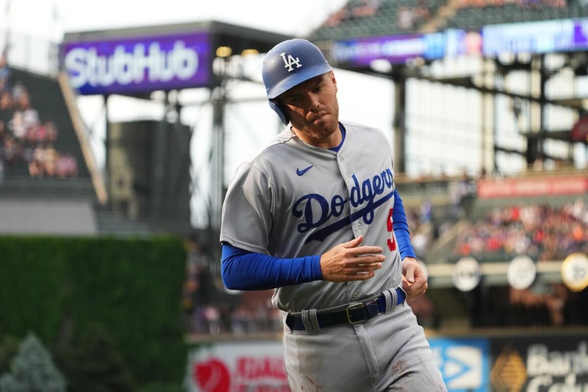 Freddie Freeman scores for the Dodgers against the the Colorado Rockies in the first inning Tuesday.