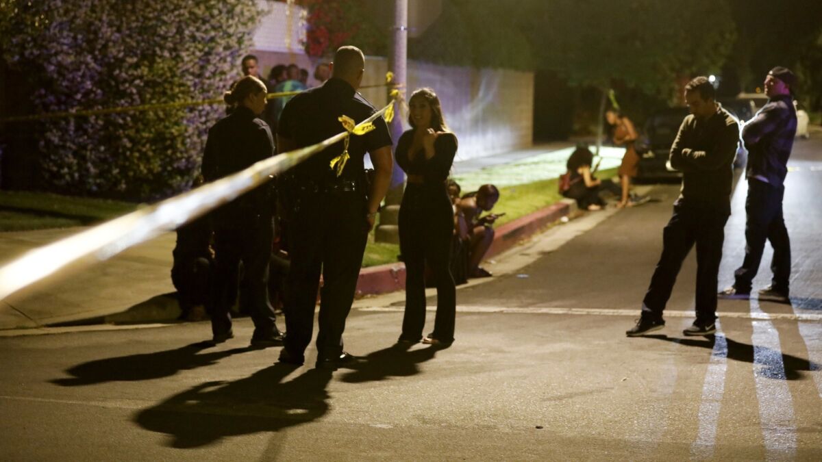 Residents stand outside the police tape after the North Hollywood shooting.