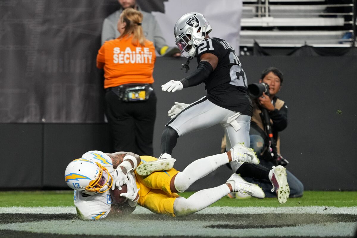 Chargers wide receiver Keenan Allen makes a touchdown grab against Raiders cornerback Amik Robertson on Dec. 4, 2022.