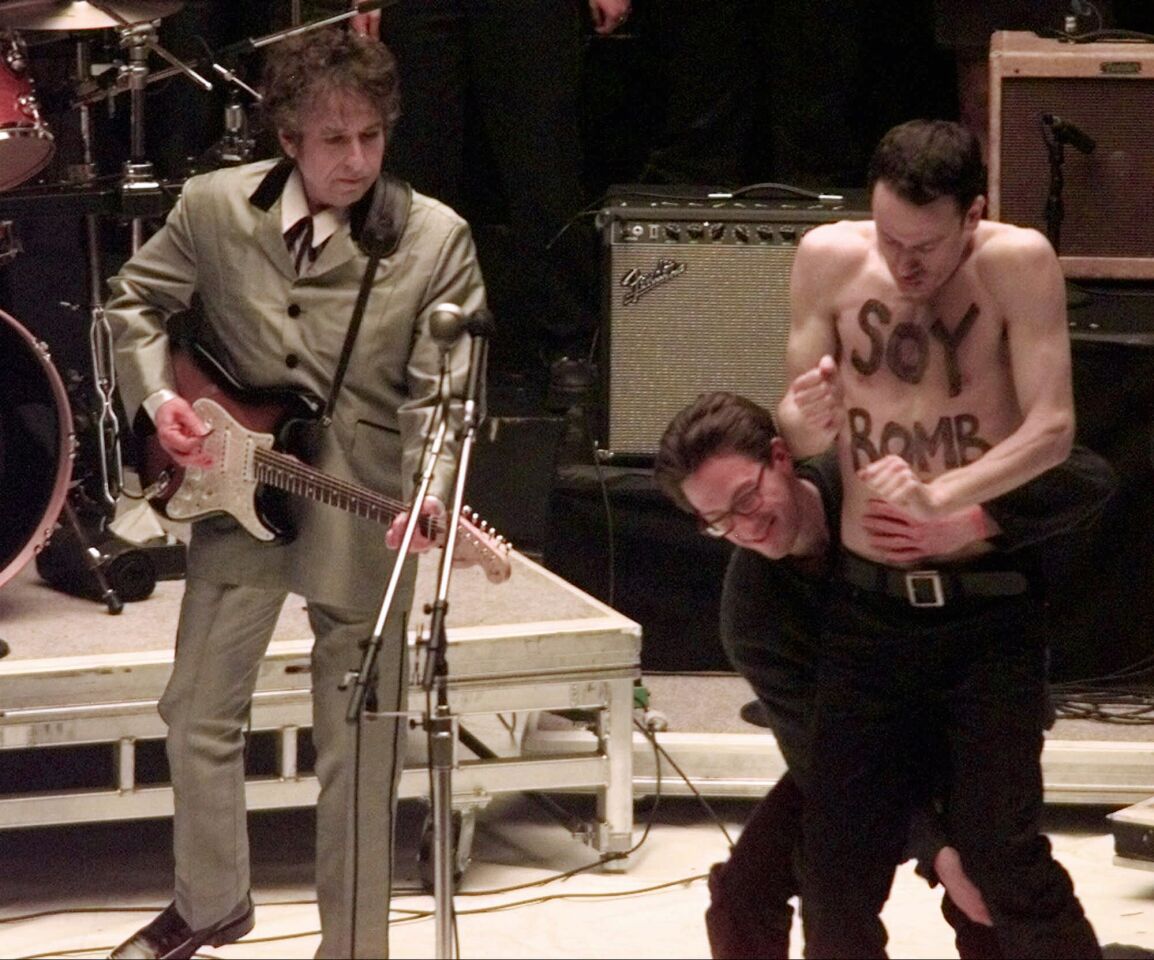 While performing the song "Love Sick" at the 1998 Grammys, Dylan was interrupted by performance artist Michael Portnoy, with the words "Soy Bomb" painted on his chest.