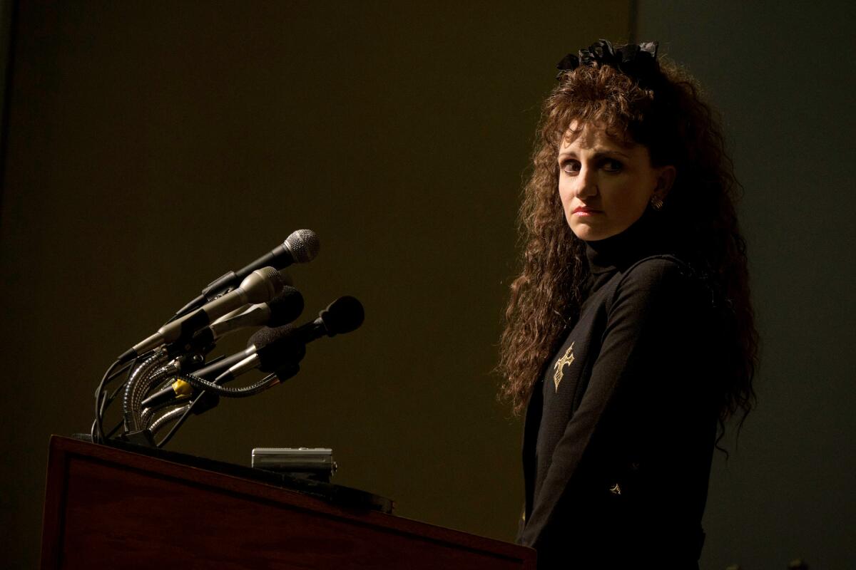 A woman at a press conference lectern