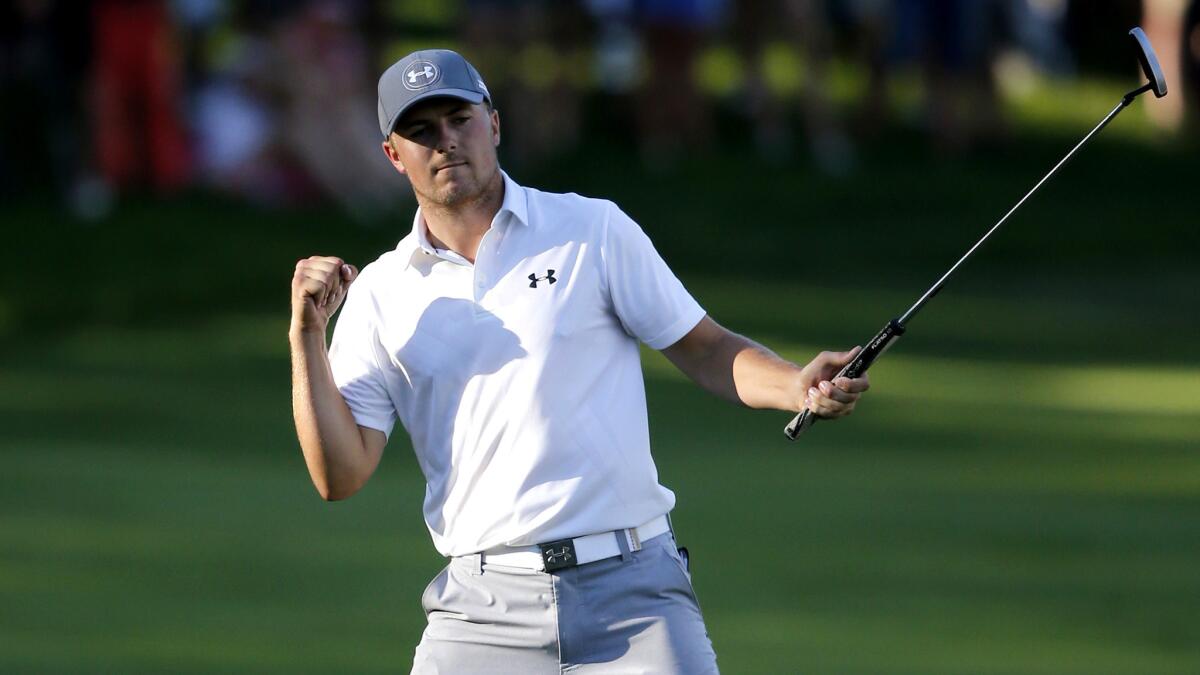 Jordan Spieth celebrates after making a birdie putt on the 18th hole to finish off a round of 61 on Saturday at the John Deere Classic.