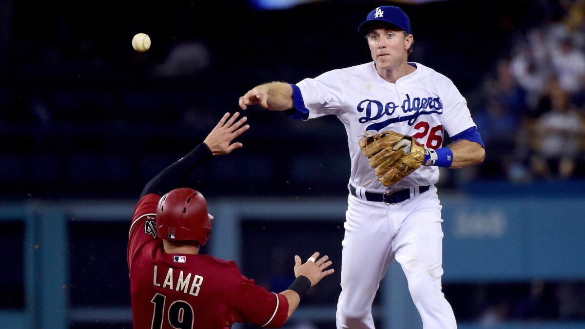 Dodgers second baseman Chase Utley makes a throw over Arizona's Jake Lamb to complete a double play at Dodger Stadium on Sept 23.