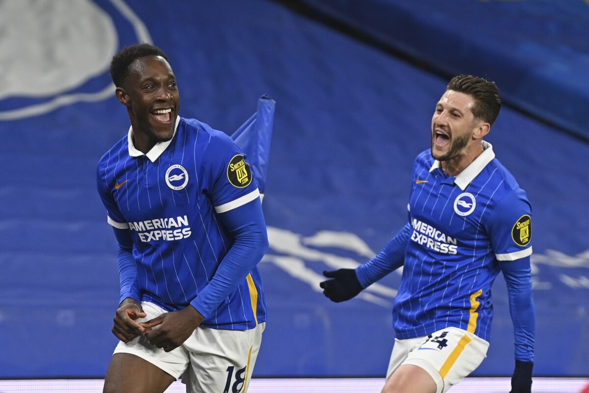 Brighton's Danny Welbeck, left, celebrates with Adam Lallana after scoring his side's opening goal during an English Premier League soccer match between Brighton & Hove Albion and West Ham United at the Amex stadium in Brighton, England, Saturday May 15, 2021. (Neil Hall, Pool via AP)