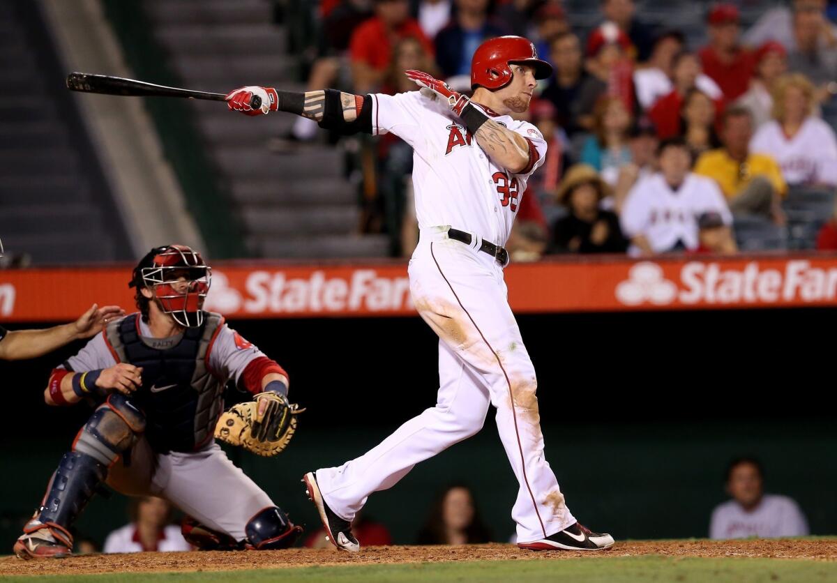 Angels outfielder Josh Hamilton hits a walk off, two-run home run during the 11th inning of the Angels' 9-7 comeback victory over the Boston Red Sox on Saturday night.