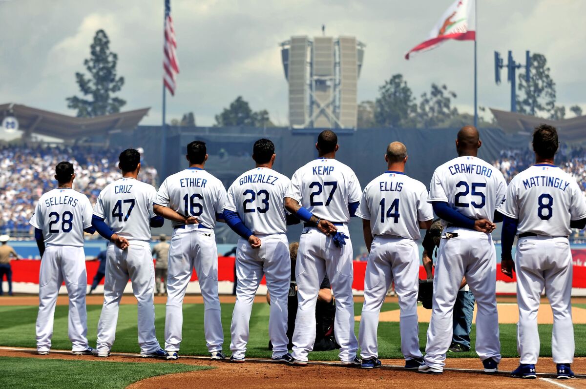 The Dodgers' starting lineup remove their caps for the national anthem on opening day, April 1, 2013. Image from the book 'The Best Team Money Can Buy: LA Dodgers' by Molly Knight.