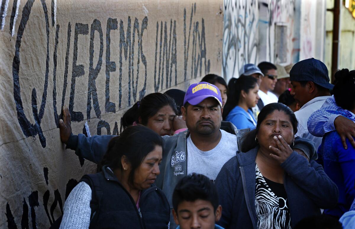 Tension shows on the faces of striking Mexican farmworkers in Baja California on Wednesday as they wait for news about ongoing salary negotiations that are now in their second week. A hand-painted sign on the wall reads in Spanish, "We want a life."