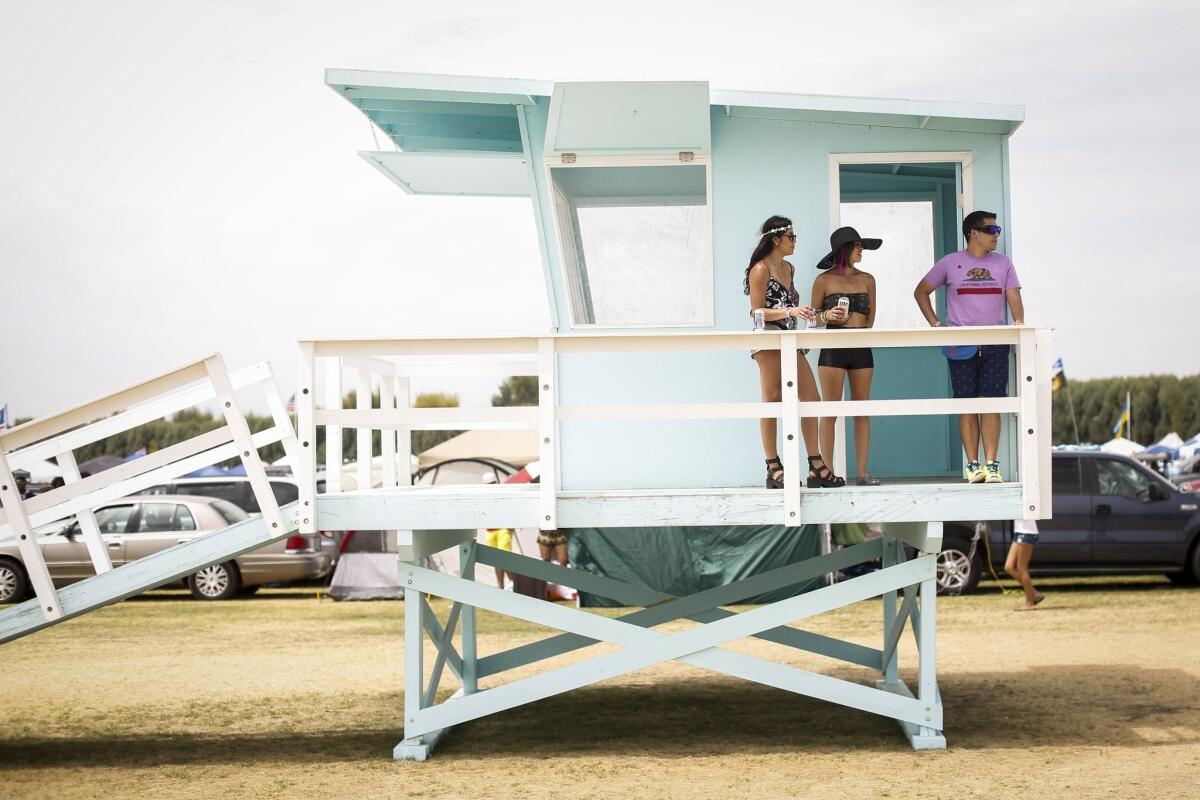 People take in the view of the car camping area from one of the art installations along "Main Street," on the first day of the second weekend of the Coachella Valley Music and Arts Festival at the Empire Polo Club in Indio, Calif., on Friday, April 18, 2014.