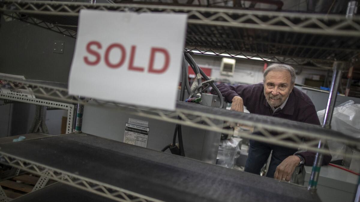 Jerry Rosenstein, president of Pioneer Magnetics, overlooks a shelf that once held his company's high-tech products. Pioneer is shutting down after having been in business since 1957.