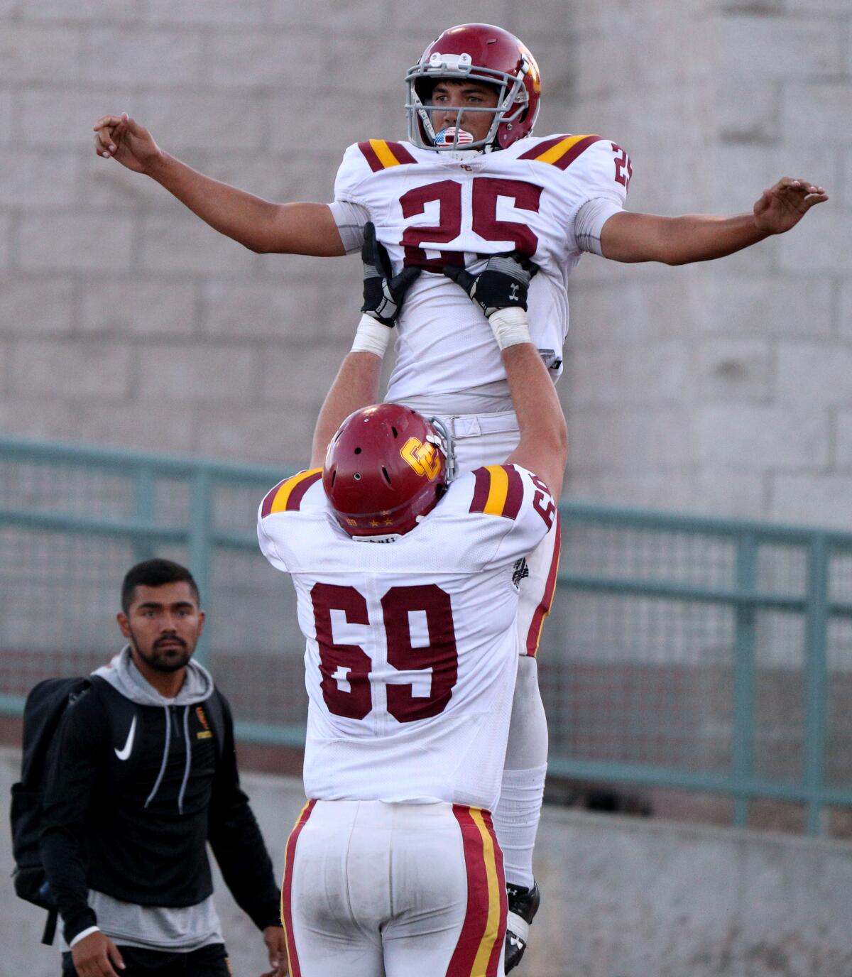 Glendale College running back Elijah Washington is lifted by Hayden Dinger after scoring a touch-down, in away game at Robinson Stadium, at Pasadena City College in Pasadena on Saturday, Sept. 14, 2019.