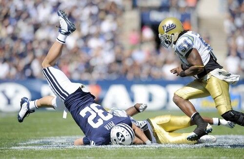 Brigham Young tight end Dennis Pitta leaps over UCLA safety Bret Lockett for a nine-yard gain in the second quarter Saturday.