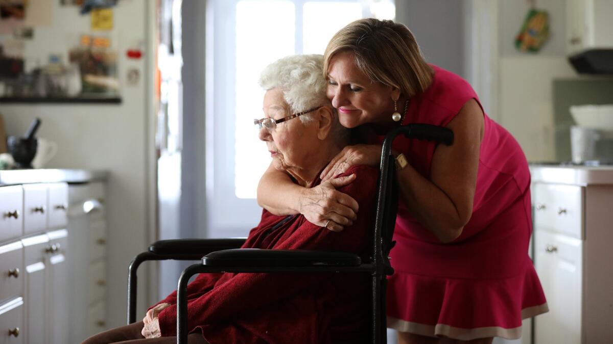 Margaret Wardlow hugs her mother Dolores McKeown, 97, in her McKeown's Cathedral City home. Wardlow was raped by the Golden State Killer in 1977, when she was 13.