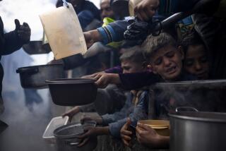 FILE - Palestinians line up for a meal in Rafah, Gaza Strip, Friday, Feb. 16, 2024. According to the Global Report on Food Crises released Wednesday, April 24, nearly 282 million people in 59 countries suffered from acute hunger in 2023, with war-torn Gaza the territory with the largest number of people facing famine. (AP Photo/Fatima Shbair, File)