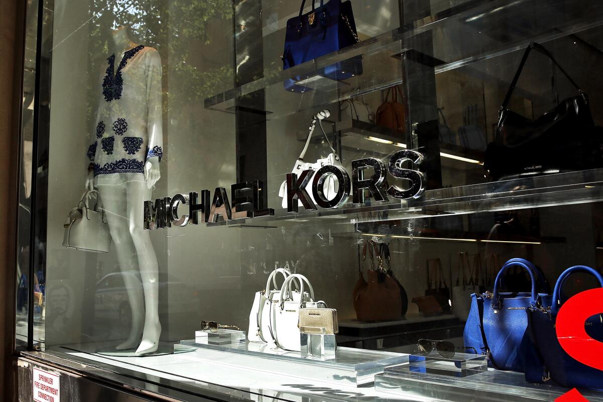 A display in a Michael Kors store window.