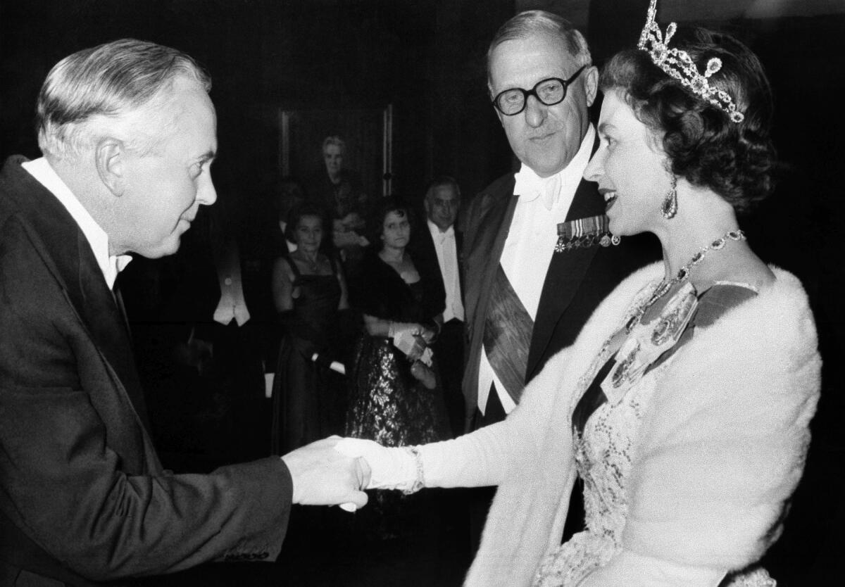 FILE - British Queen Elizabeth greets Prime Minister Harold Wilson at a reception in County Hall, Westminster, London on Nov. 11, 1964. In seven decades on the throne, Queen Elizabeth II saw 15 British prime ministers come and go, from Winston Churchill to Margaret Thatcher to Boris Johnson to Liz Truss. (AP Photo, File)