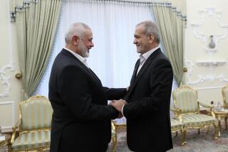 In this photo released by the Iranian Presidency Office, President Masoud Pezeshkian, right, shakes hands with Hamas chief Ismail Haniyeh at the start of their meeting at the President's office in Tehran, Iran, Tuesday, July 30, 2024. (Iranian Presidency Office via AP)