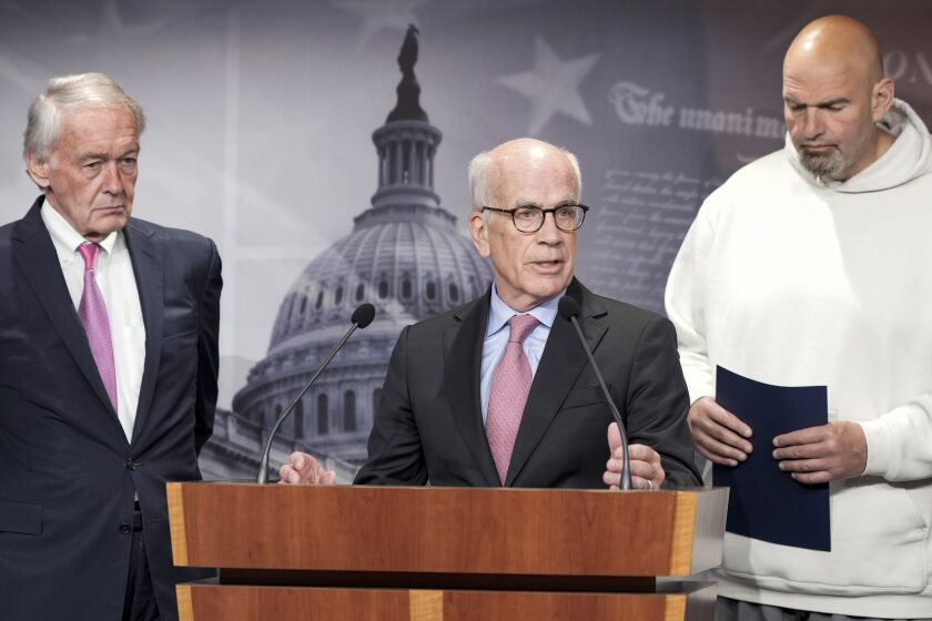 FILE - Sen. Peter Welch, D-Vt., center, speaks as Sen. Edward Markey, D-Mass., left and Sen. John Fetterman, D-Pa., right, listen during a news conference on the debt limit, Thursday, May 18, 2023, on Capitol Hill in Washington. Male senators are expected to wear a jacket and tie on the Senate floor, but Fetterman has a workaround, he votes from the doorway of the Democratic cloakroom or the side entrance, making sure his “yay” or “nay” is recorded before ducking back out. (AP Photo/Mariam Zuhaib, File)
