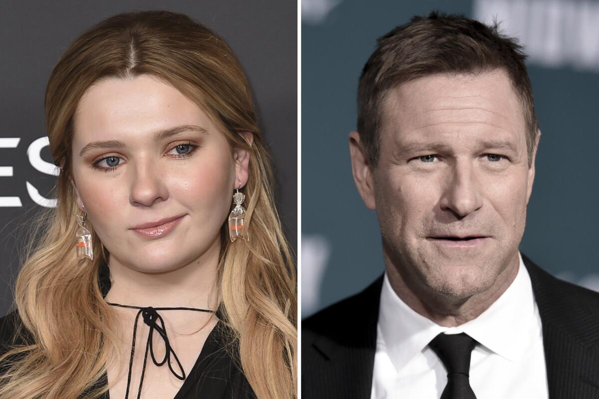 Separate headshots of Abigail Breslin in a black cape dress and dangly earrings and Aaron Eckhart in a black suit 