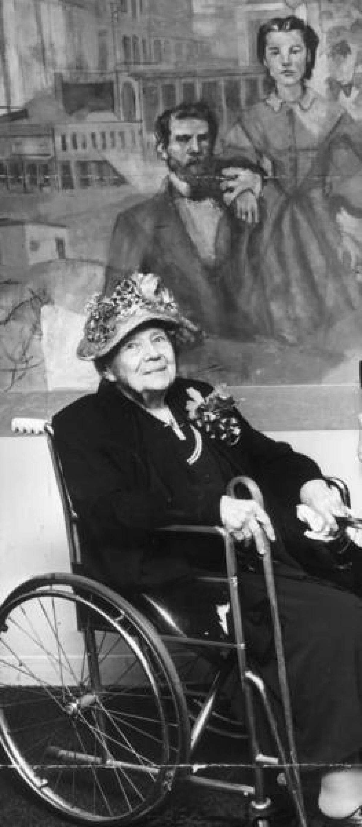 Mary E. Foy in front of a mural of her parents, Samuel and Lucinda Foy, in the Statler Hotel's Foy Room at 7th and Figueroa streets (now the Omni Hotel) in 1957. The mural was eventually painted over. (Los Angeles Times)