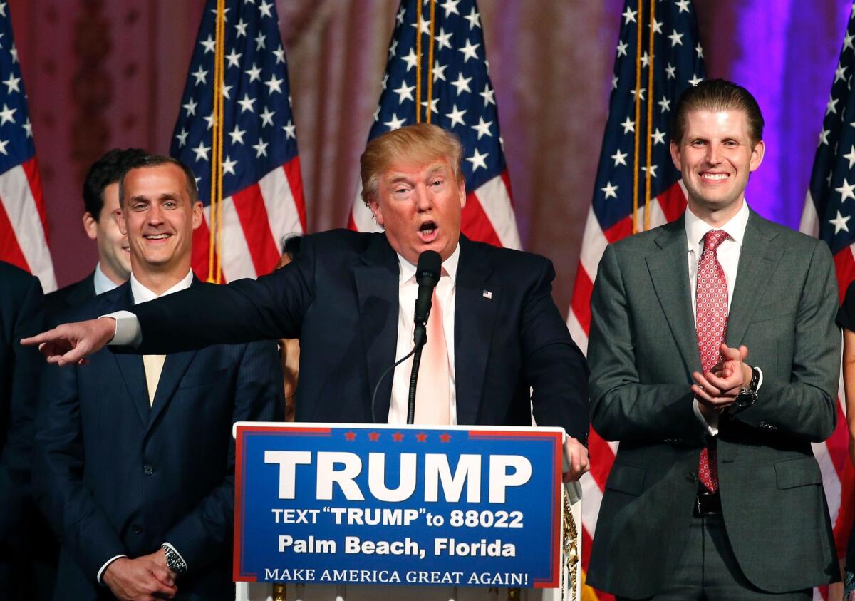 Donald Trump, with his son, Eric, right, and campaign manager, Corey Lewandowsky, left, speaks to supporters and the news media Tuesday night in Palm Beach, Fla.