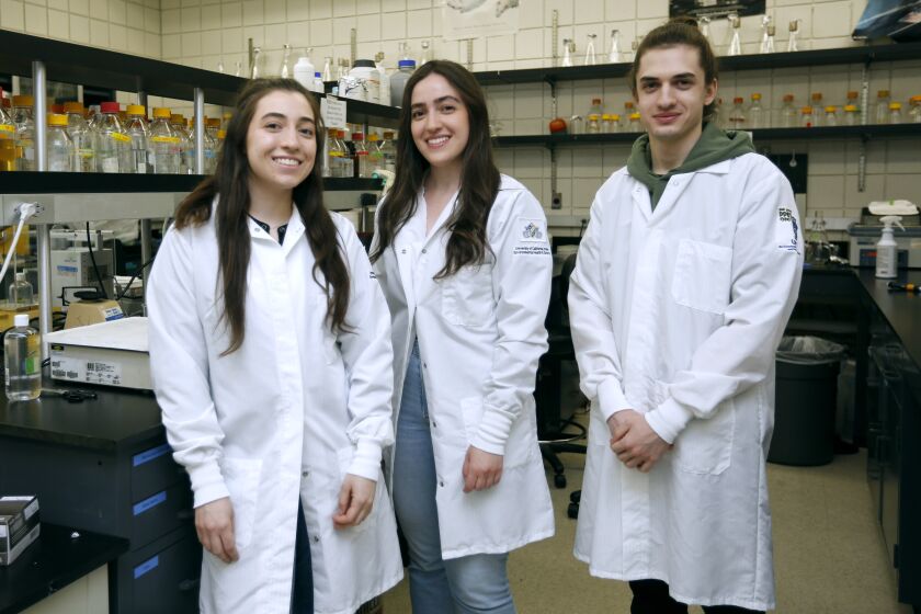 From left, siblings Wedad Alhassen, 25, Lamees Alhassen, 26, and Sammy Alhassen, 23, at a laboratory on the University of California, Irvine campus where they are doctoral students at the new School of Pharmacy and Pharmaceutical Sciences, on Thursday, Aug. 13, 2020.