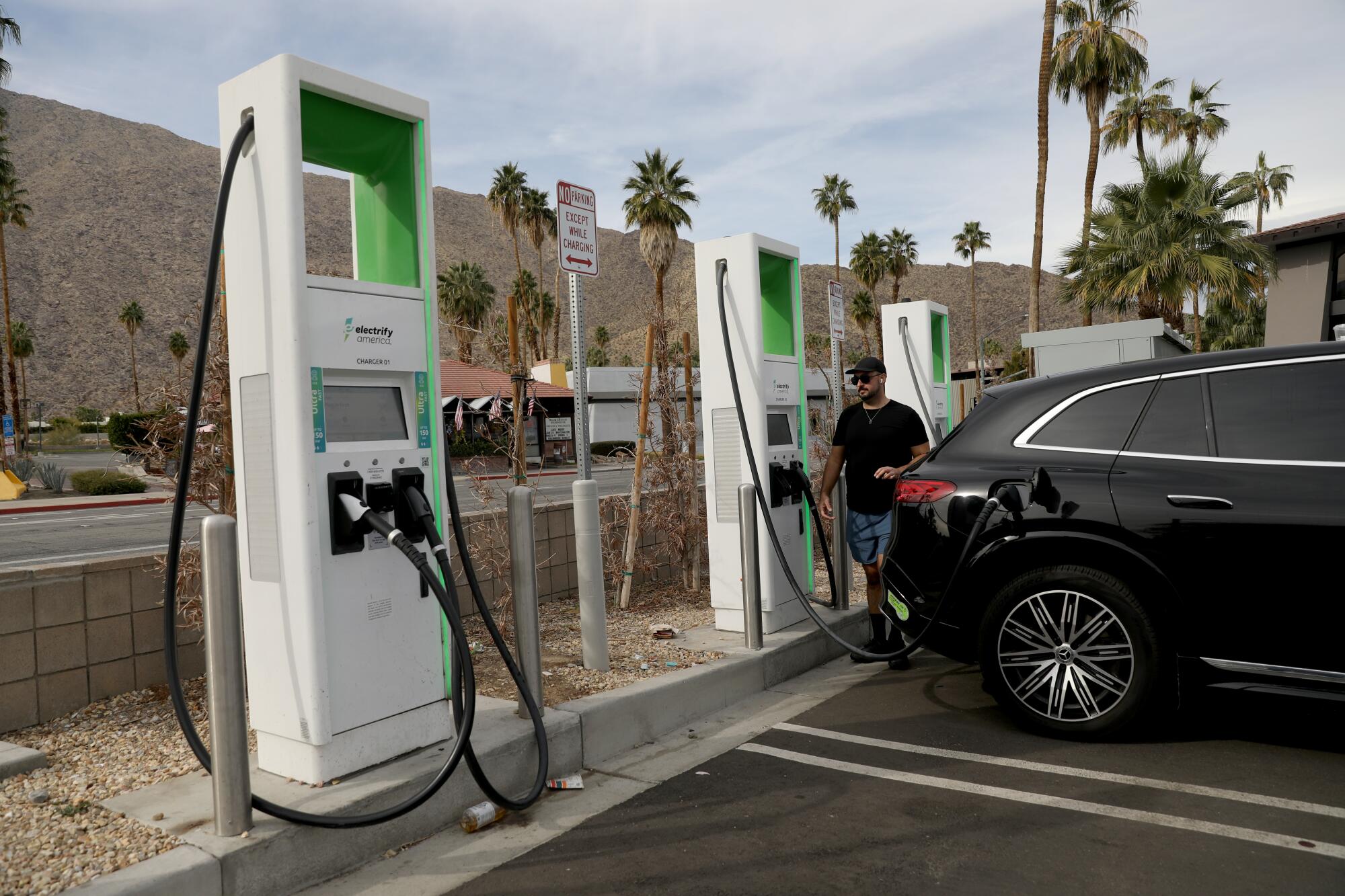 A man charges an EV in Palm Springs