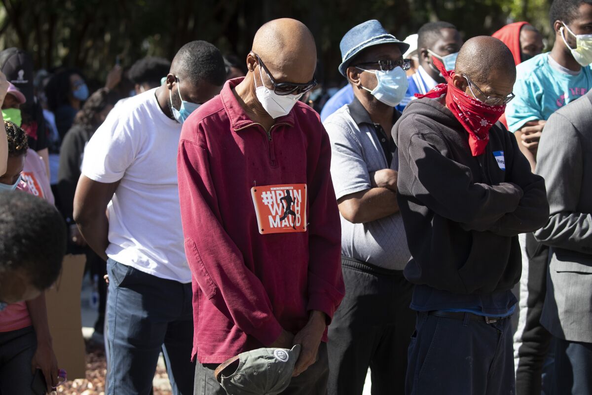 People pray during a rally to protest the shooting of Ahmaud Arbery, an unarmed black man in Brunswick, Georgia.