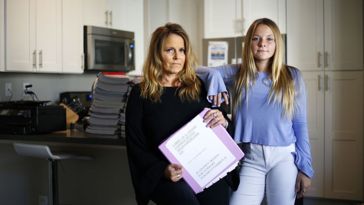 Susan Carré is a former tenant of Solana Highlands who is now suing developer H.G. Fenton for injuries her children allegedly suffered as a result of exposure to mold while living there. Carré is shown at with her daughter Skylar and binders of paperwork at her Del Mar home.