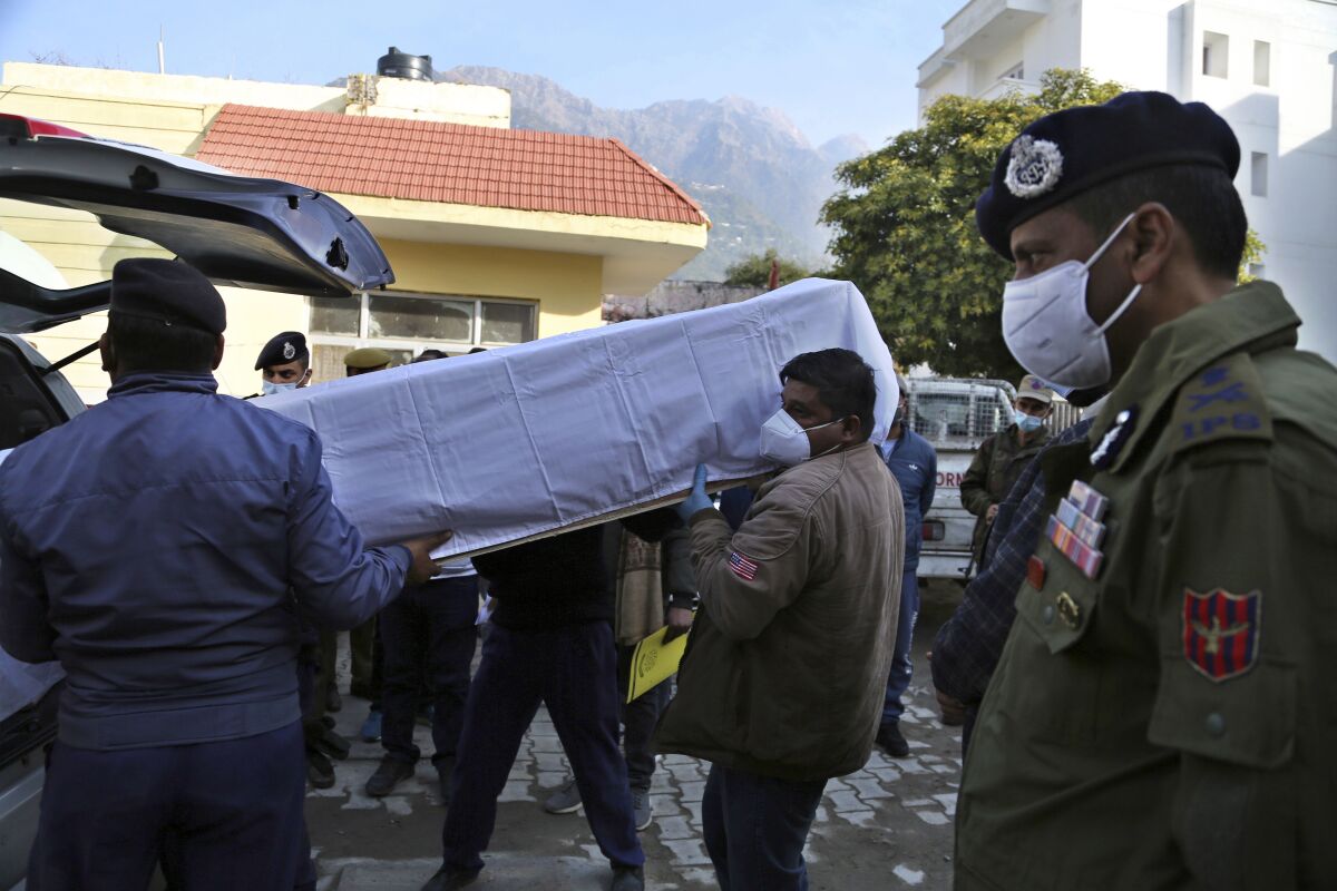 India health workers carry a coffin.