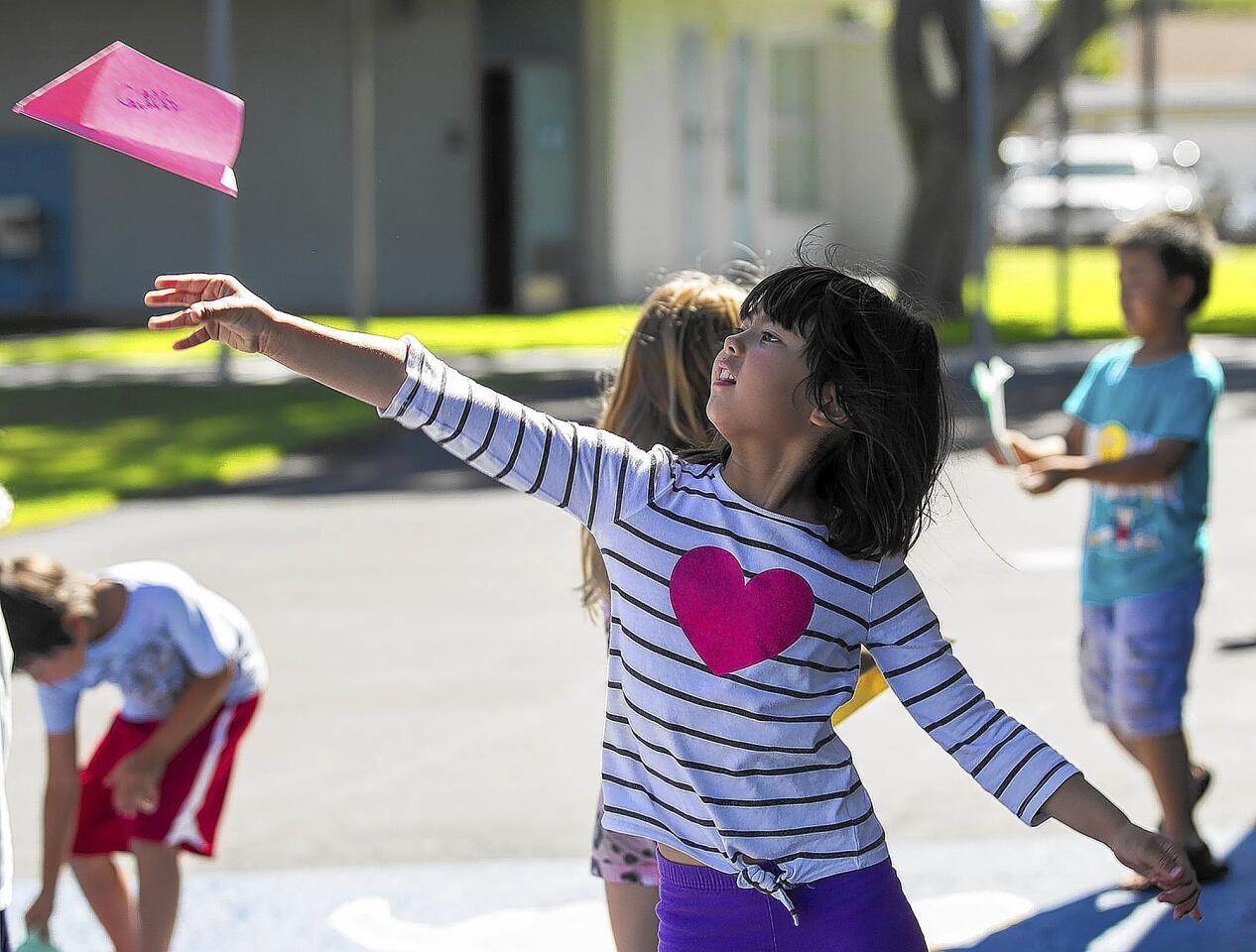 Caitlin Stayt, 7, launches her paper airplane during the final day of summer engineering camp at Killybrooke Elementary School on Thursday, July 24.