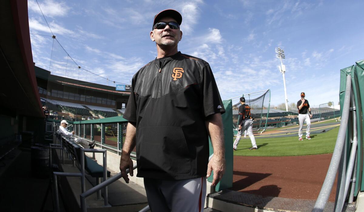 Manager Bruce Bochy (15) talks with fans during spring training baseball practice last week before it was discovered he needed a heart procedure.