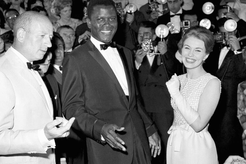 Actor Sidney Poitier appears at the Cannes Film Festival, Cannes, France, for the showing of his film "A Raisin in the Sun," May 13, 1961. At right is actress Jean Seberg. (AP Photo)