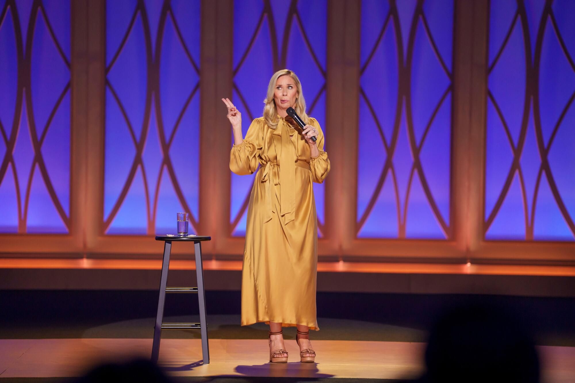 Leanne Morgan speaks into a microphone onstage