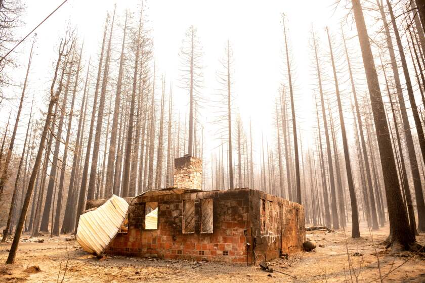 TOPSHOT - The remains of a home smolders during the Caldor fire in Twin Bridges, California on September 1, 2021. - At least 650 structures have burned and thousands more are threatened as the Caldor fire moves into the resort community of South Lake Tahoe, California. (Photo by JOSH EDELSON / AFP) (Photo by JOSH EDELSON/AFP via Getty Images)