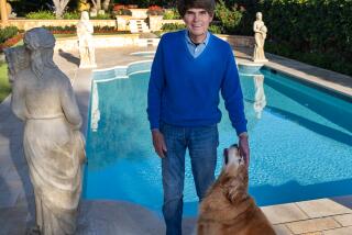 Irvine, CA - December 12: Bestselling author Dean Koontz is photographed with he and his wife, Gerda's beloved dog, Elsa, at their home in Irvine Tuesday, Dec. 12, 2023. Koontz is the author of the Odd Thomas and Jane Hawk series, as well as many standalone suspense novels, most recently "After Death" and "The House at the End of the World." His books have sold more than 500 million copies and are published in 38 languages. Koontz lives in Orange County with his wife, Gerda, and their golden retriever, Elsa. He is a longtime benefactor of Canine Companions for Independence. (Allen J. Schaben / Los Angeles Times)