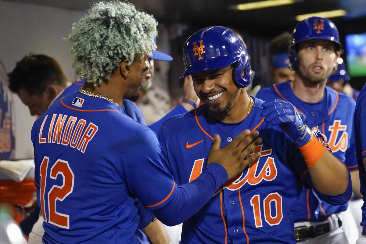 New York Mets' Eduardo Escobar (10) celebrates with Francisco Lindor (12) after hitting a two-run home run during the sixth inning of a baseball game against the Washington Nationals, Tuesday, May 31, 2022, in New York. (AP Photo/Mary Altaffer)