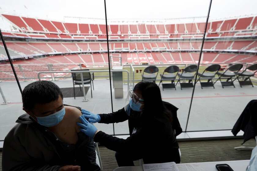 A man gets a COVID-19 shot at Levi's Stadium in Santa Clara.