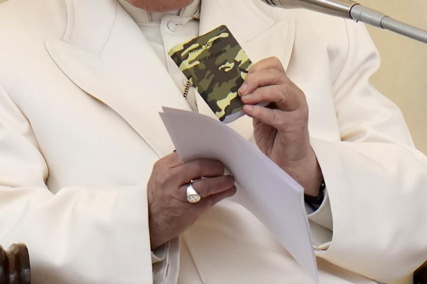 Pope Francis holds his weekly general audience in St. Peter's Square, at the Vatican, Wednesday, April 3, 2024. Pope Francis showed tourists and pilgrims the rosary and Gospel booklet that the 23-year-old Ukrainian Alexander had with him when he was killed in Russia's war.(AP Photo/Alessandra Tarantino)