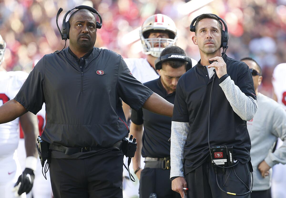 San Francisco tight ends coach Jon Embree, left, stands with head coach Kyle Shanahan as the 49ers play the Rams on Oct. 21, 2019, in Santa Clara.