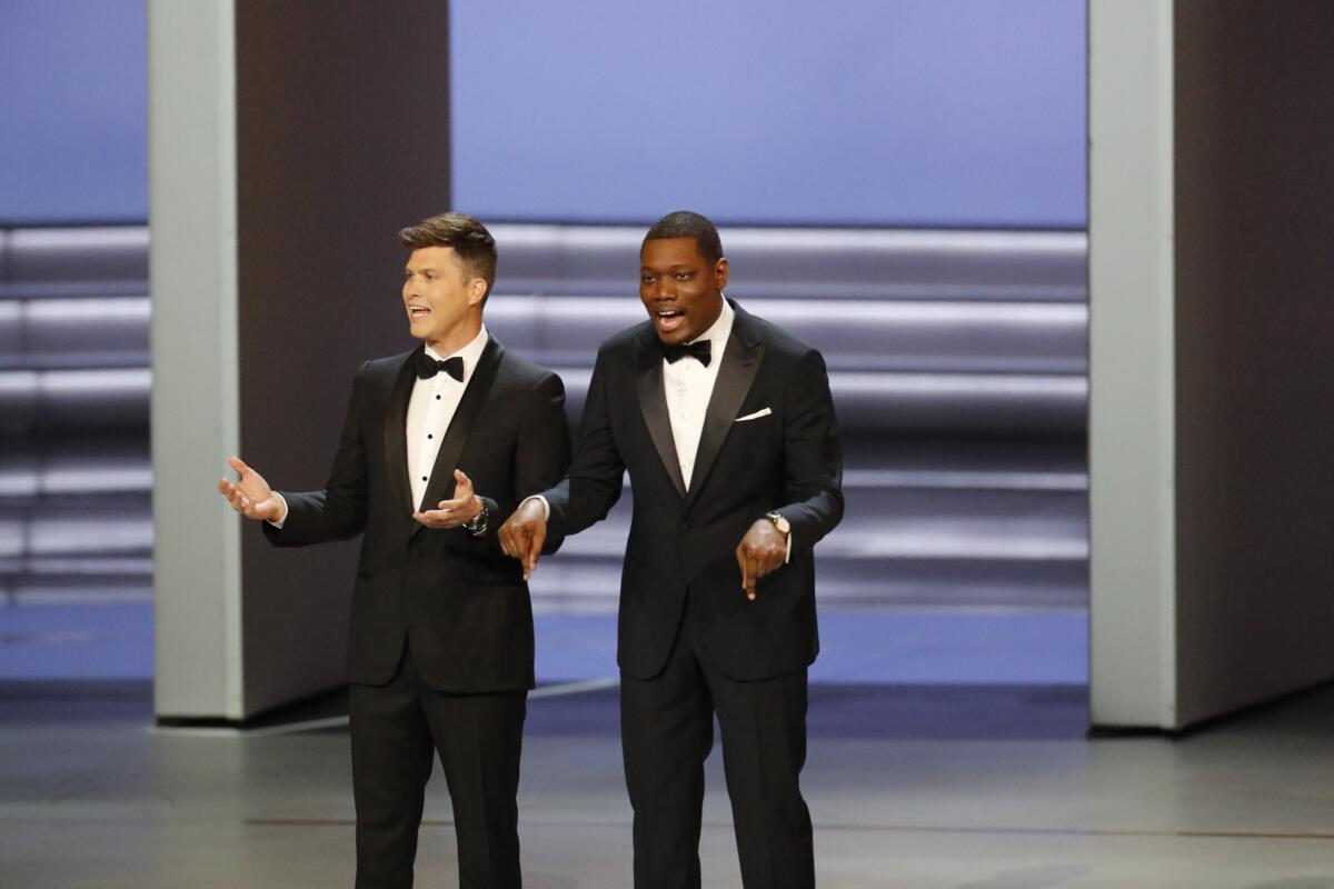 Colin Jost, left, and Michael Che host the 70th Primetime Emmy Awards.