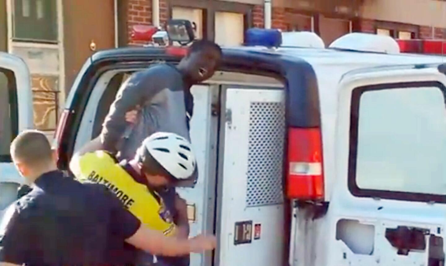 Frame grab from Kevin Moore's April 12, 2015, cellphone video of Freddie Gray being loaded into a Baltimore police van during his arrest. At some point during his time in custody, Gray, 25, fell into a coma and died April 19 from injuries to his spinal cord sustained that day. A task force was created by Baltimore Police to investigate Gray's arrest and his death.