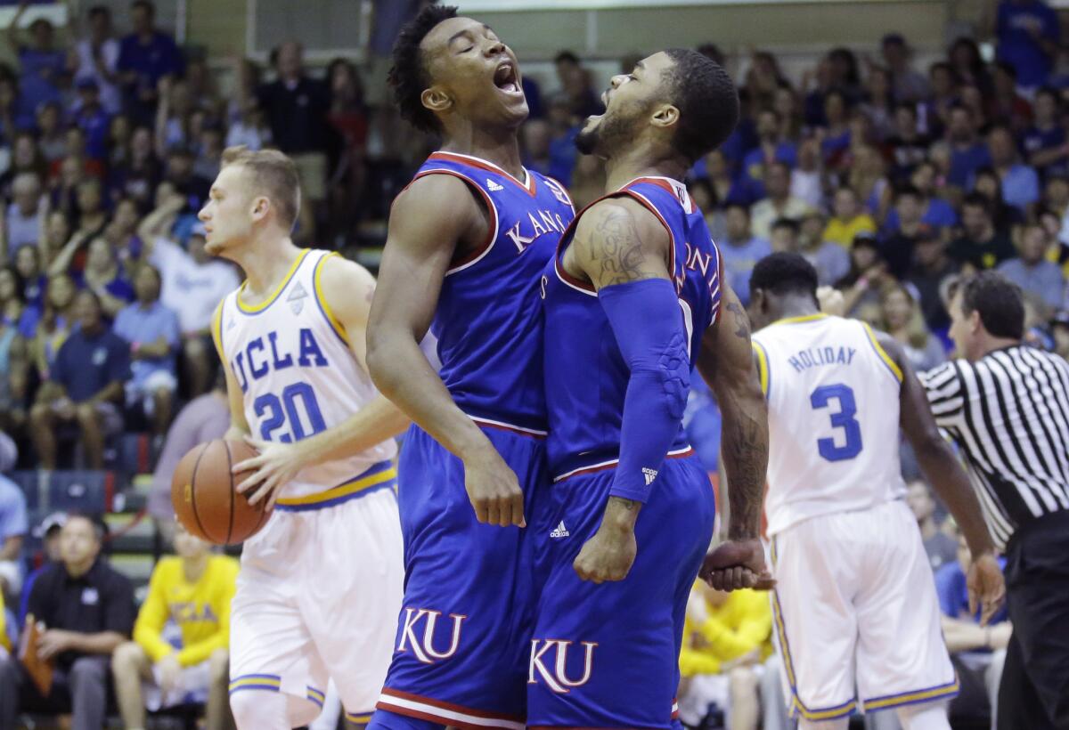 Kansas guard Frank Mason III celebrates with guard Devonte' Graham, left, after scoring against UCLA during the first half of a game at the Maui Jim Maui Invitational on Nov. 24.