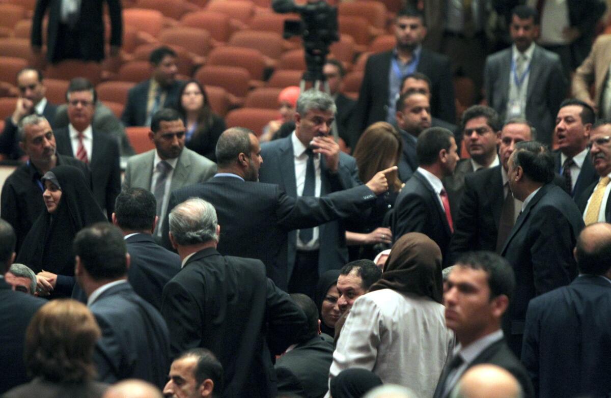 Kadhim Sayadi, a Shiite Muslim lawmaker in Prime Minister Nouri Maliki's bloc, points a finger as he argues with Kurdish deputies at a chaotic parliamentary session Tuesday.