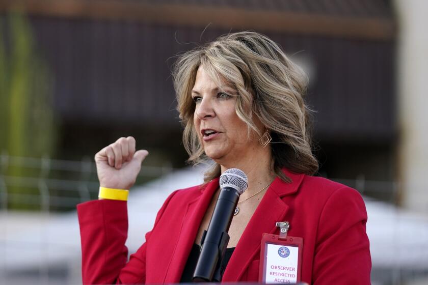 FILE - Kelli Ward, chair of the Arizona Republican Party, holds a press conference at the Maricopa County Elections Department in Phoenix on Nov. 18, 2020. Ward, who led the state GOP from 2019 until early 2023, was scheduled to be arraigned on Tuesday, May 21, 2024, on felony charges in Arizona’s fake elector case for her part in the effort to overturn Donald Trump’s loss to Joe Biden in the 2020 election. (AP Photo/Ross D. Franklin, File)