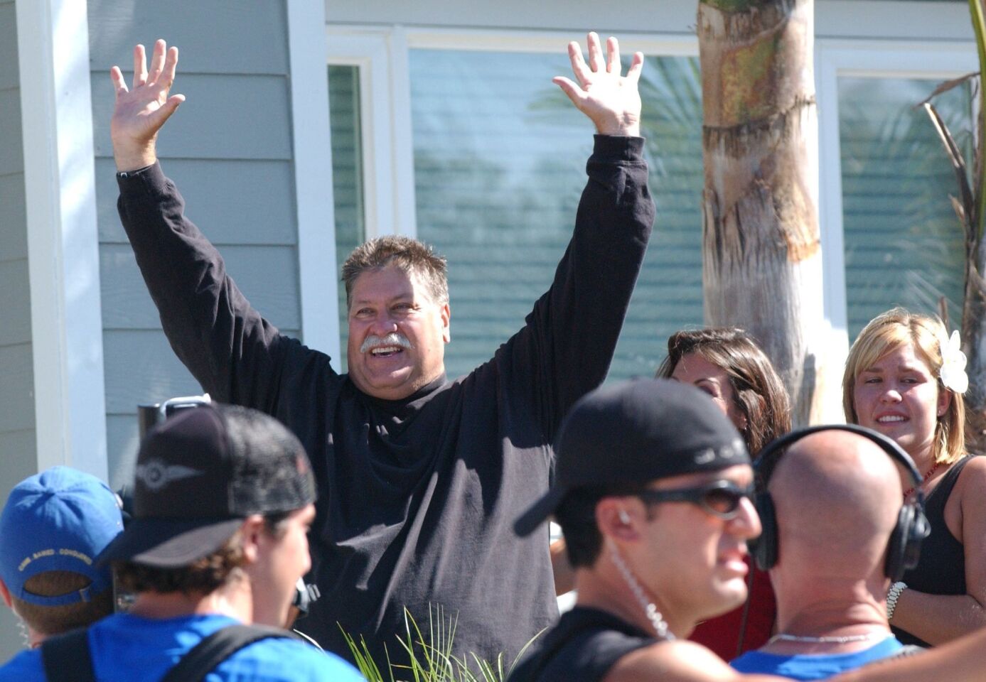 Brian Wofford waves to a large crowd gathered outside his home shortly after seeing his remade home for the first time on June 30, 2004. The house received a radical makever by the design team from the ABC-TV program "Extreme Makeover: Home Edition."