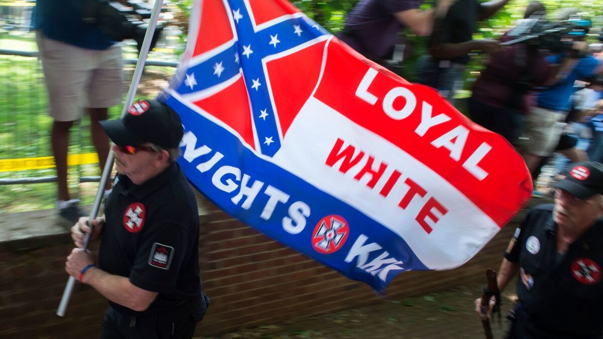 Members of the Ku Klux Klan arrive at a rally in Charlottesville, Va. on July 8, 2017.