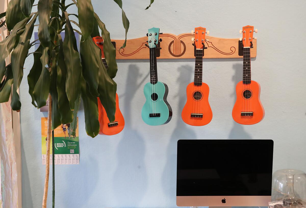 Ukeleles hang in the game room of the Waymakers Huntington Beach Youth Shelter.