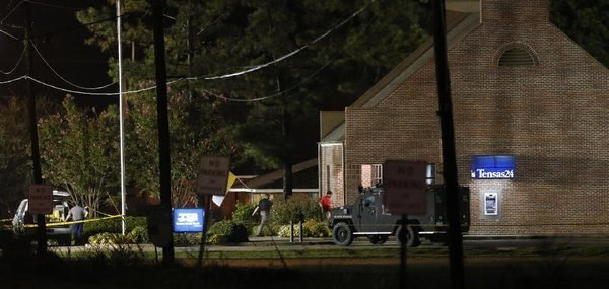 Investigators work through the early morning hours at the Tensas State Bank branch in St. Joseph, La., where a gunman took three people hostage Tuesday.