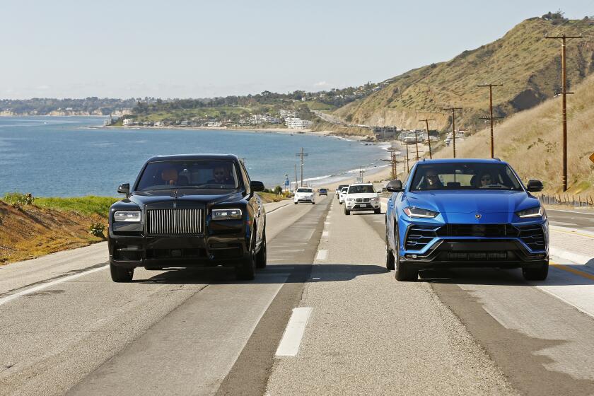 MALIBU, CA - JANUARY 21, 2020 The Lamborghini Urus in blue and the Rolls-Royce Cullinan in black are photographed in Malibu for a comparison with the rise of the UUV (ultra utility vehicle). The stars are the Lamborghini Urus and the Rolls-Royce Cullinan with a two-fold vibe; elegant and urban; and sandy/beachy/off-road.(Al Seib / Los Angeles Times)